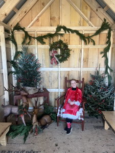One of Santa's helpers sits in Santa's workshop
