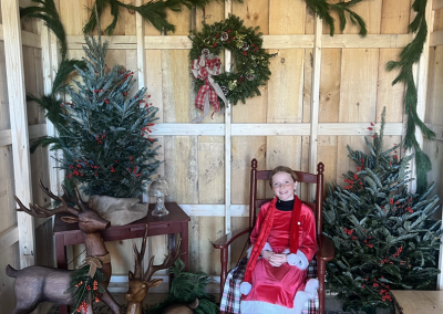 One of Santa's helpers sits in Santa's workshop